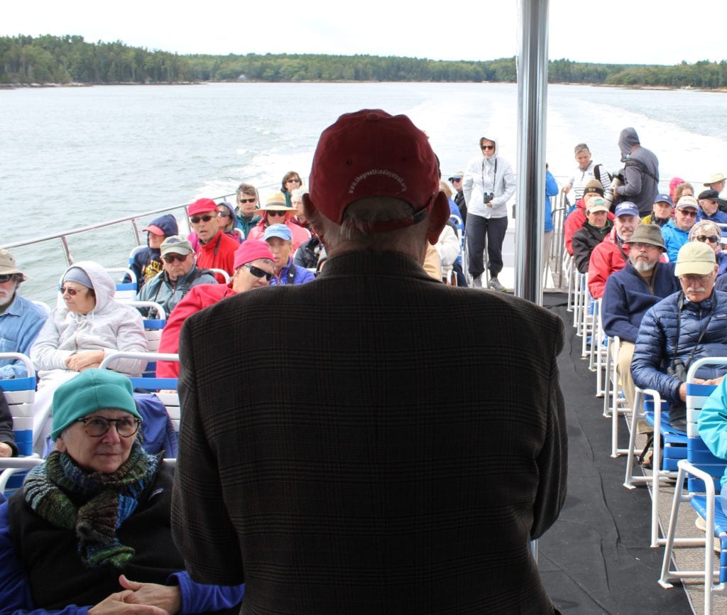 Dick Anderson speaking to trip participants atop the boat