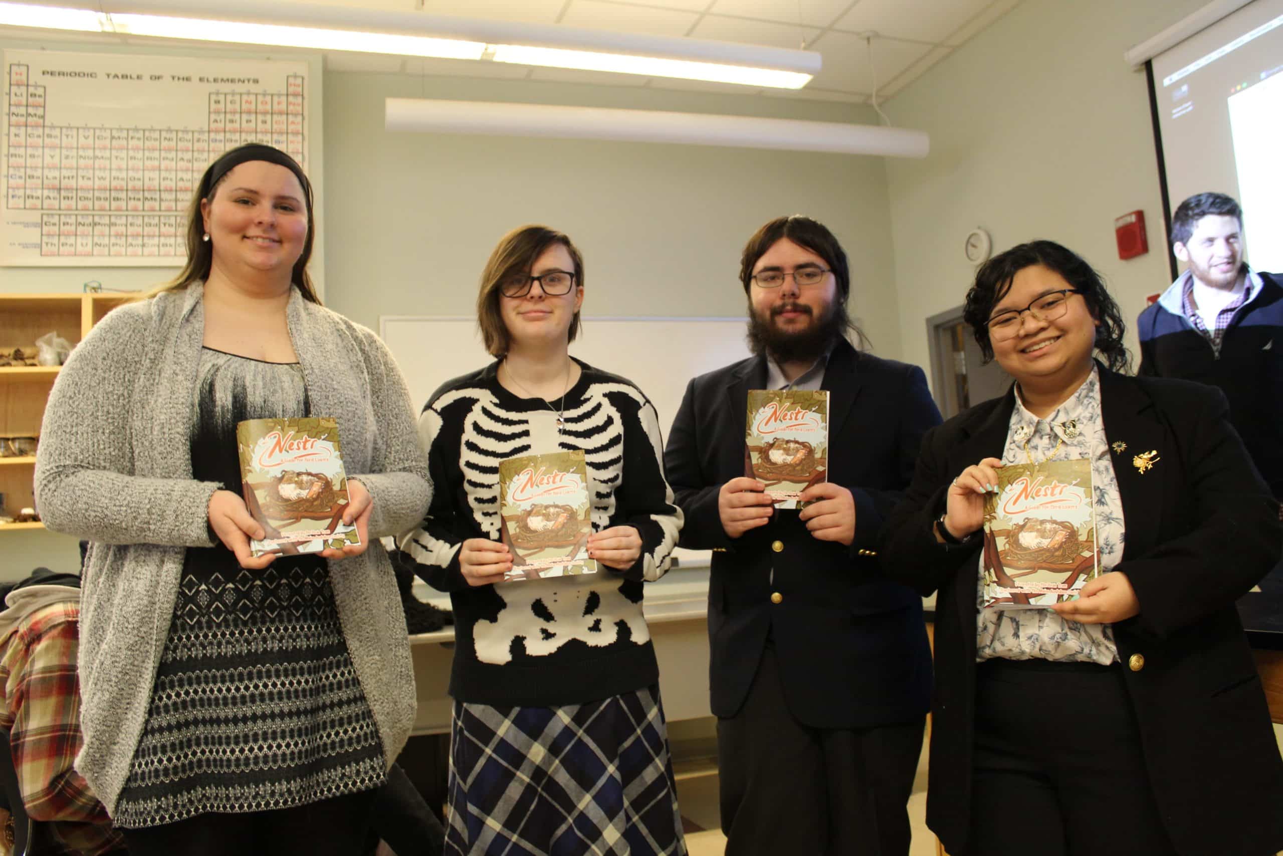 Members of the Bean Team pose with their Nestr brochure. (l-r) Calea Roy, Regan King, Corey Boynton, April Azutillo