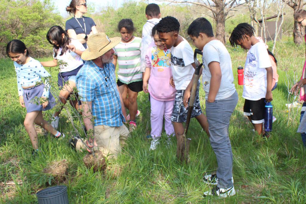 Students from the Reiche Elementary School, taking part in the Learning Works afterschool enrichment program, plant native plants at Kettle Cove State Park, Cape Elizabeth. 