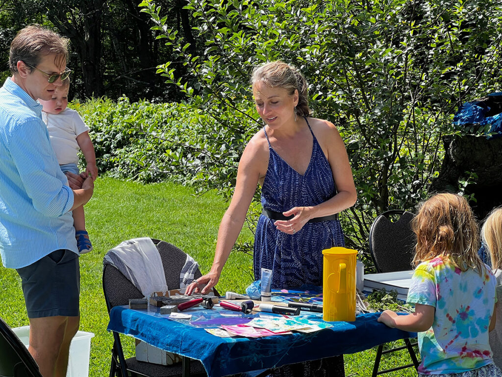 Artist Jessica Barzell leads visitors in the art of sun prints/cyanotypes