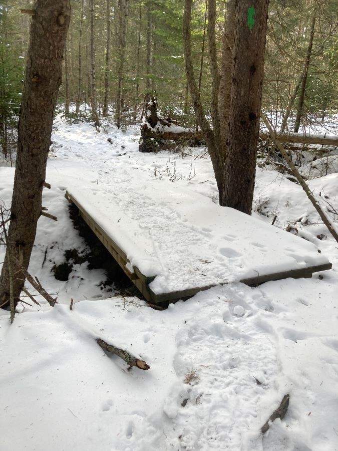 Trails in winter: snowpack on bridge