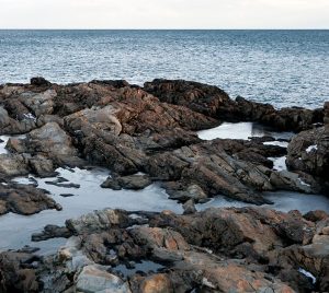 East Point Audubon Sanctuary looking over rocks out to the dark blue sea